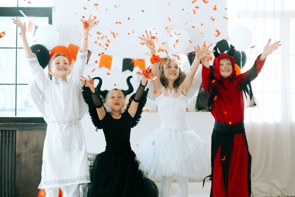 Kids having fun dressed up in costumes at halloween party