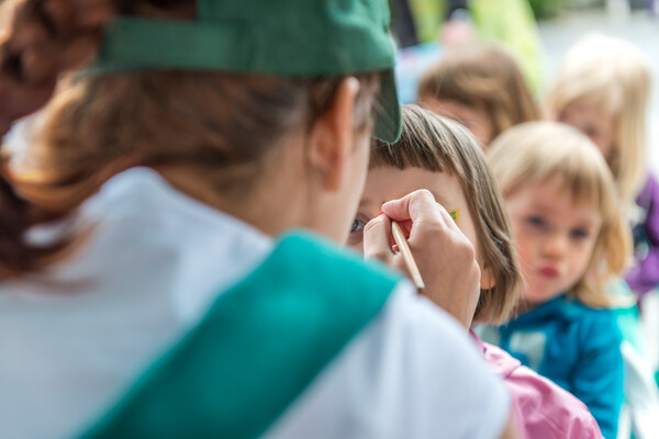 Kids lining up for face painting at school carnival