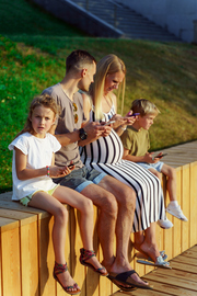 Family outside glued to their phones.