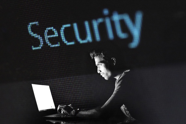 Man in dark room checking his security settings