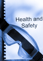 Protective goggles laying on top of school health and safety manual.