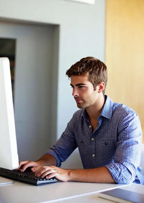 Student at home doing homework on his computer