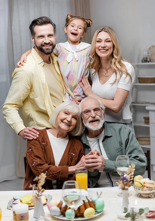 Three generations gather for photo around the dinner table.