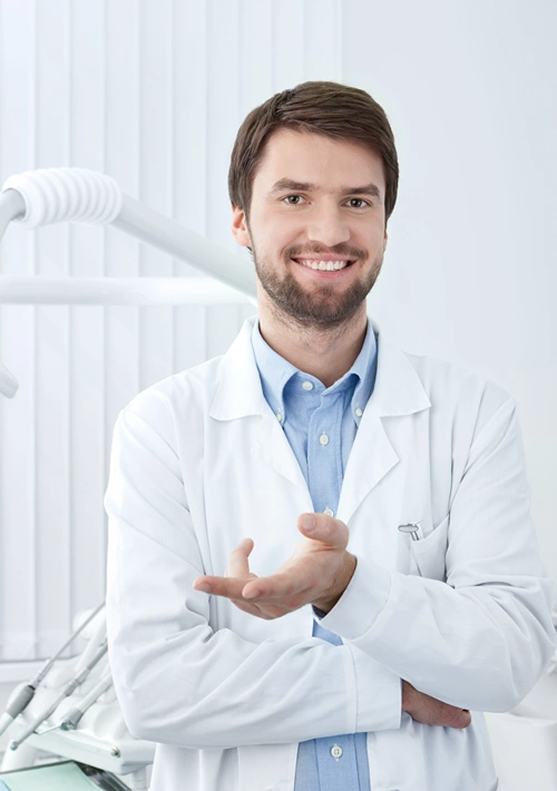 A dentist smiling as he talks.