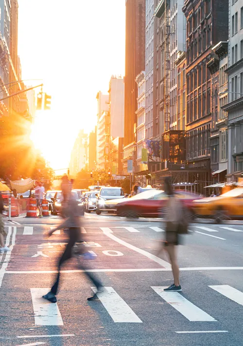 Blurred people on a busy city crosswalk.