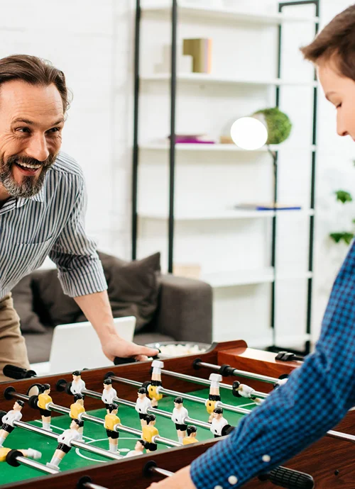 Father and Son having a blast playing foosball.