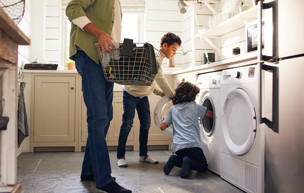 Two boys are helping with the household laundry.