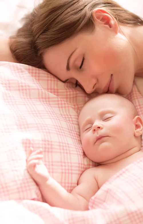 New mother napping closely with her baby.