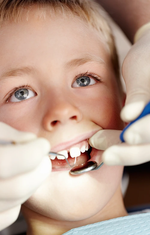 A young boy's teeth is being examined at ortho clinic.