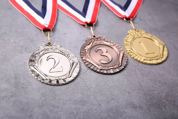 First, second, and third place medals.