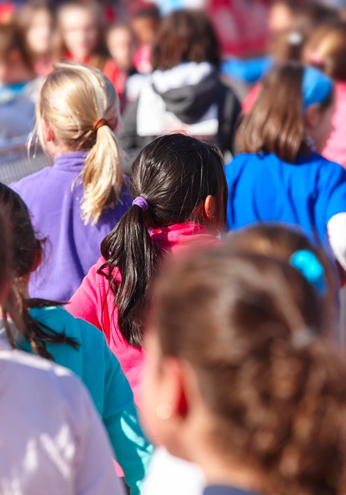 Group of students gather outside school during fire drill.