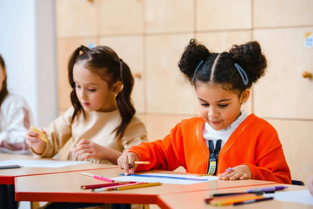 Girls in classroom working at their desks.