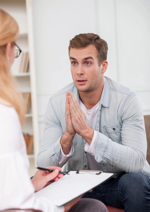 A young man in counseling session with therapist.