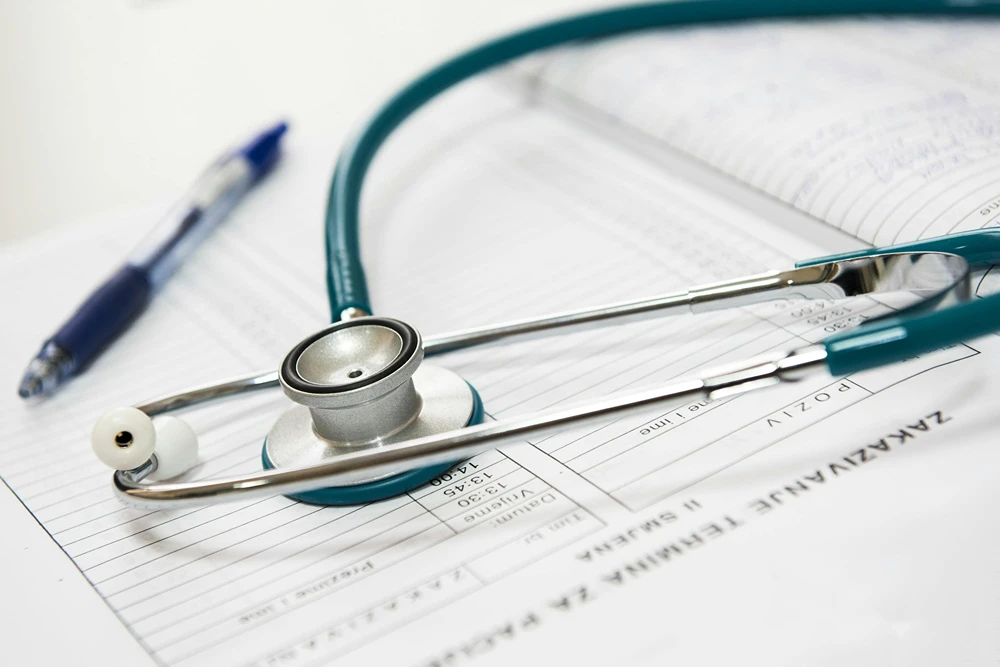 A stethoscope laying on a clinical appointment schedule.