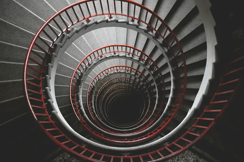 Looking down a long and ominous spiral staircase.