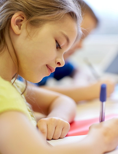 A girl writing the The 11+ Exam.