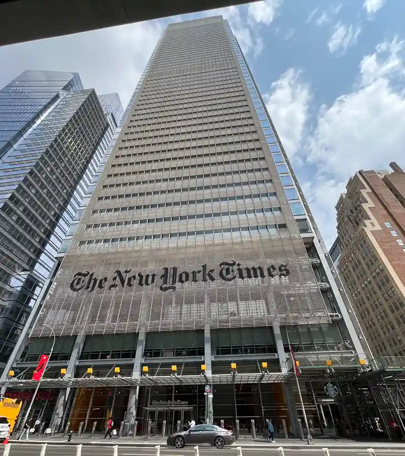 Standing outside The New York Times, the home of my favorite online crossword puzzles and word games.