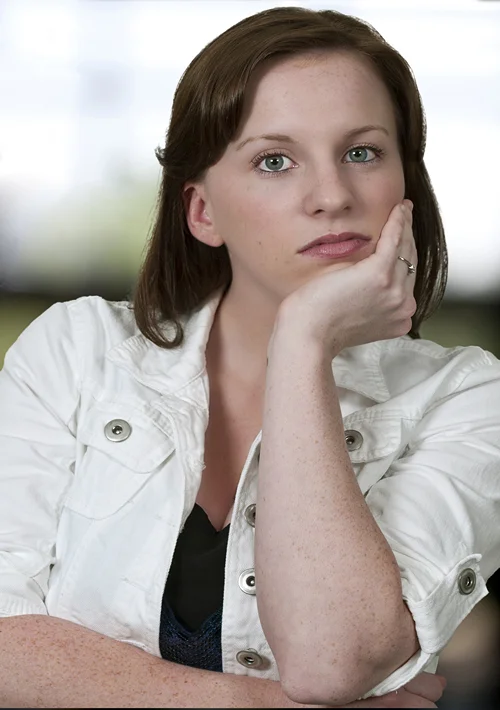 Woman stairs at camera with serious look on her face.