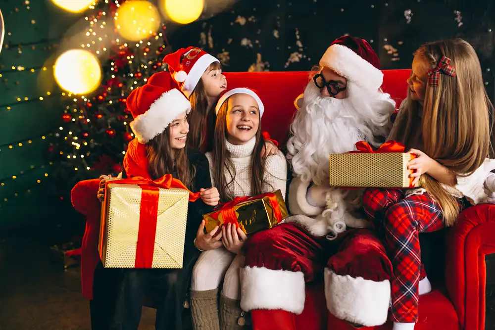 A group kids sitting with Santa at a Christmas party.