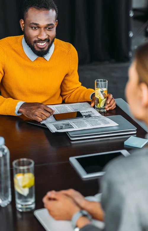 A male and female business partners meeting together.