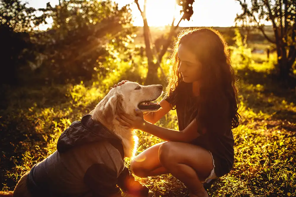 A girl with her golden retriever.  