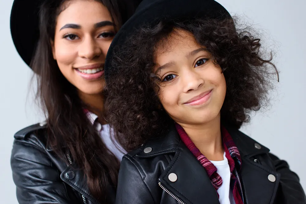 Happy and Mother and Teen in matching outfits.