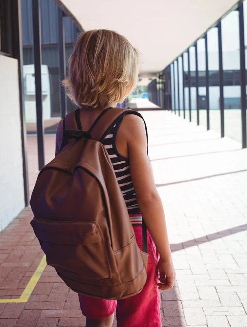 Apprehensive boy enters school.