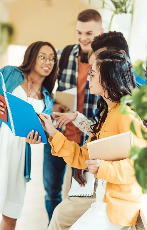 Group of university students with note books