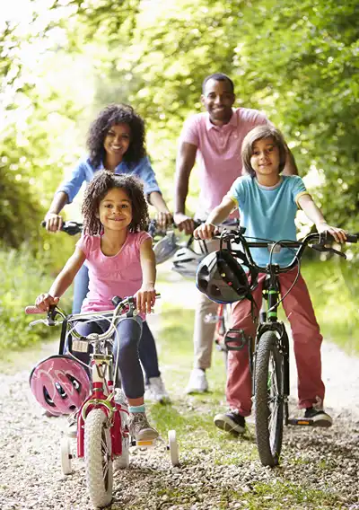 A family riding bikes together on a trail.
