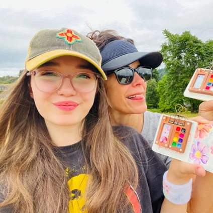 Two Women show off their Tobios Kits outdoors in a meadow.