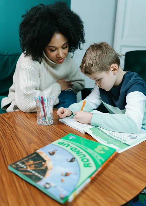 A tutor with a young boy.