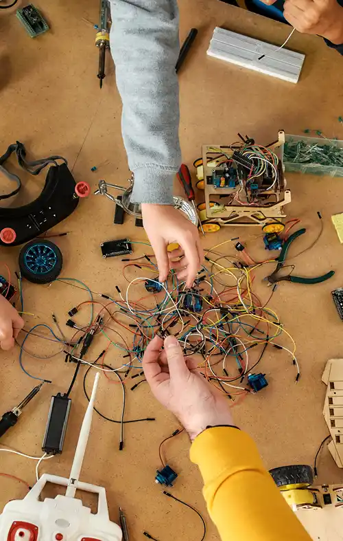Young students are wiring tires for their science project.