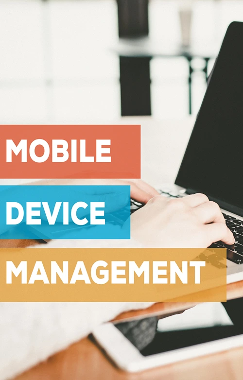 The block letters of the words MOBILE DEVICE MANAGEMENT over top of hands typing on a laptop.