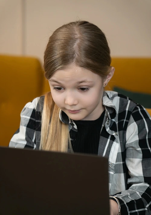 Middle aged school girl searching Google on a laptop.