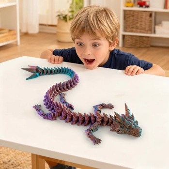 A wide-eyed excited little boy views a toy dragon on a table.