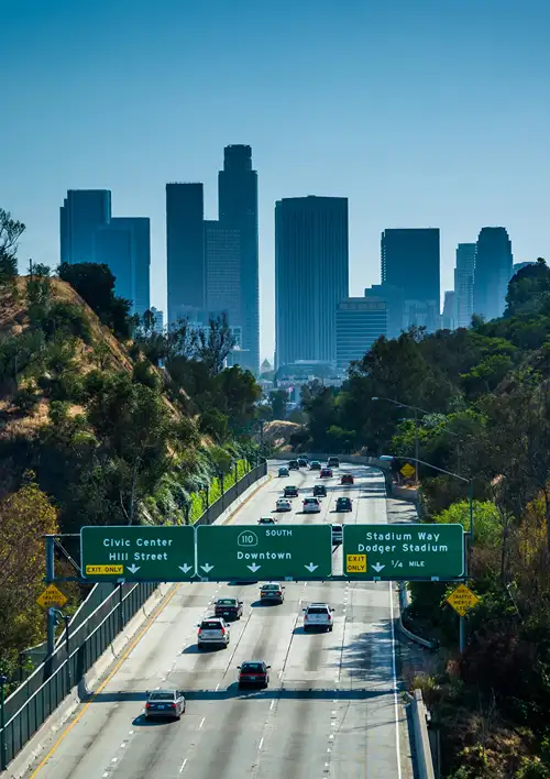 Cars on the 110 freeway to the skyline of downtown Los Angeles.
