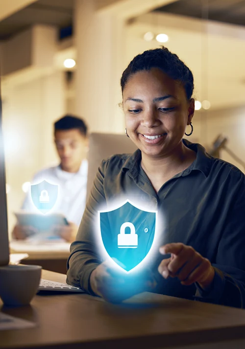 Make and female students using devices that show a security emblems over top.